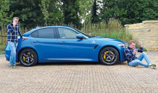 Two Sean Carsons standing with the Alfa Giulia